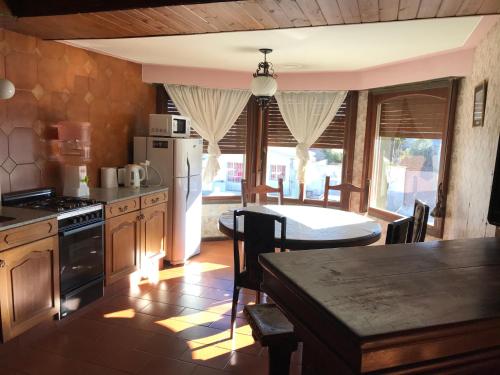 a kitchen with a table and a dining room at SWEET HOME PATAGONIA in Comodoro Rivadavia