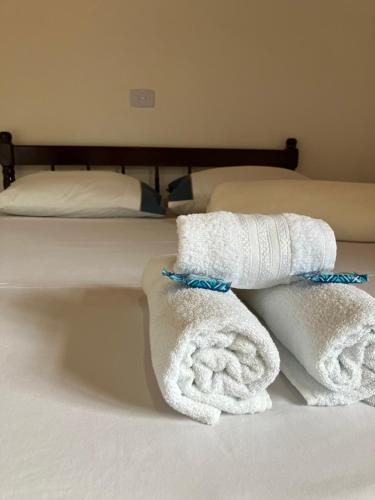 a bed with white towels on top of it at POUSADA JOSÉ DA ROSA in Santo Antônio do Pinhal