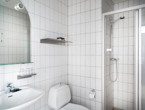 a bathroom with a toilet and a sink and a shower at Hotel Kea by Keahotels in Akureyri