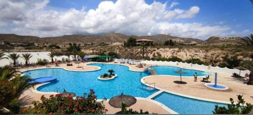 a resort with a large pool with people in it at Vivienda en El Campello playa in El Campello