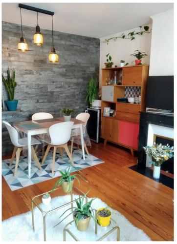 a living room with a table and chairs and a fireplace at Cosy apartment PARIS XIIème in Paris