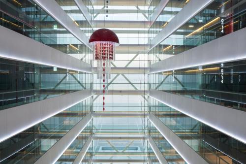 a glass building with a basketball hanging from the ceiling at MYRIAD by SANA Hotels in Lisbon