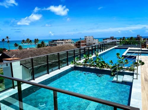a view of the pool from the balcony of a resort at Flat Premium No Centro in Porto De Galinhas