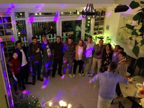 a group of people standing in a room with purple lights at Pretty Backpackers House in Da Lat
