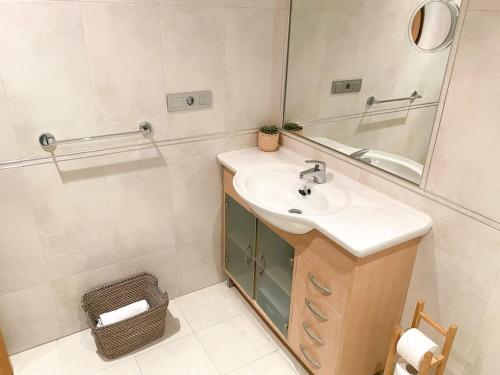 a bathroom with a sink and a mirror at Apartamento acogedor con vistas al mar. in A Coruña