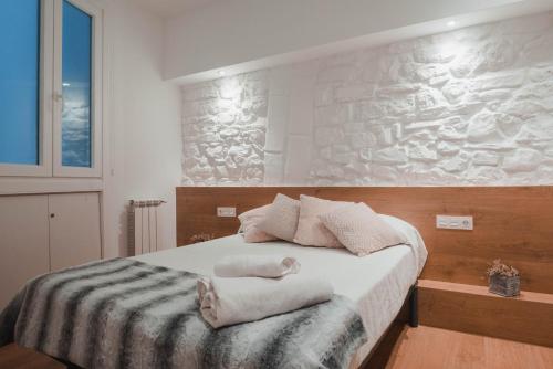 a bedroom with a bed with two towels on it at Apartamento Zurriola by SanSe Holidays in San Sebastián