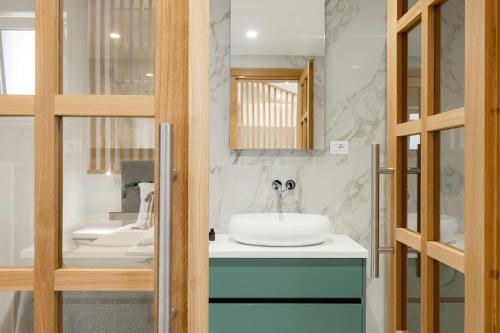 a bathroom with a sink and a mirror at Apartment Cerin Prizba in Blato