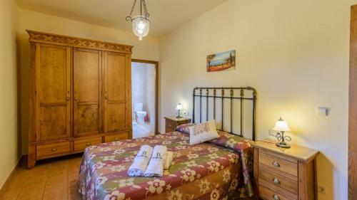 Un dormitorio con una cama y un tocador con toallas. en La Molina de la Campana Villaviciosa de Córdoba by Ruralidays, en Villaviciosa de Córdoba