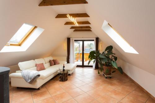 a living room with a white couch and skylights at Ferienwohnung Aurora in Winsen