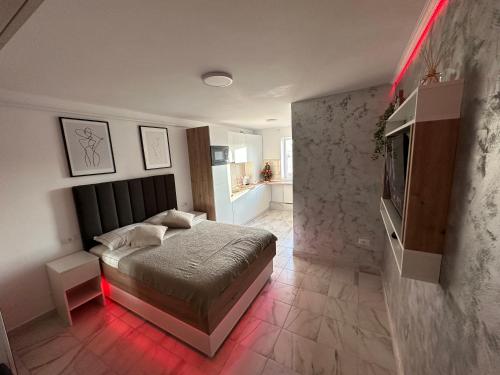 a bedroom with a bed with a red light at Exclusiv Room in Iaşi