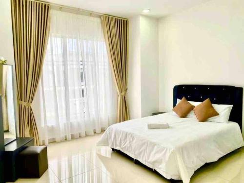 - une chambre avec un lit et une grande fenêtre dans l'établissement D’Royale Desaru Homestay, à Bandar Penawar