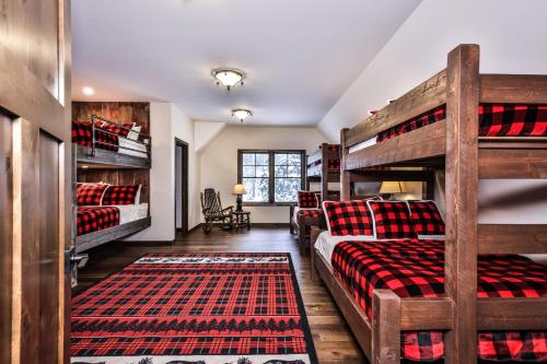 a bedroom with two bunk beds and a couch at Endless Summer in Sayner