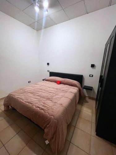 a bedroom with a bed with a red flower on it at Holiday Studio Castel di Sangro in Castel di Sangro