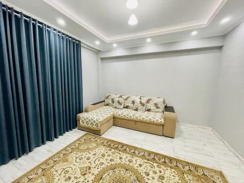 a living room with a couch and a rug at # 268 Светлая и уютная квартира in Atyrau