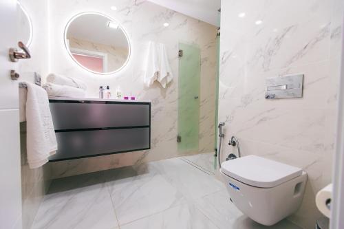 een badkamer met een toilet, een wastafel en een spiegel bij Luxury 2 bedroom apartment in Los Cristianos in Los Cristianos