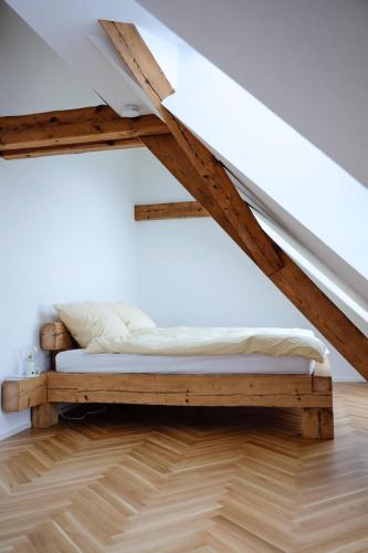 a bed on a wooden platform in a room at Trautesheim Ferienwohnungen in Wangen im Allgäu