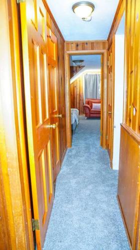 a hallway with wooden doors and a blue carpet at Spacious 4BR Family & Work-Friendly Home, Close to Airport in Columbus