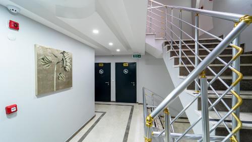 a staircase in a building with two elevators at KUMBAĞ ŞEHRİ SARAY APART OTEL in Tekirdag