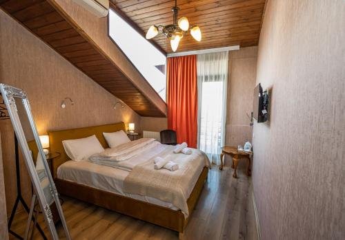 a bedroom with a large bed in a attic at Hotel Old Tbilisi 5 rooms in Tbilisi City