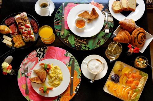 a table with plates of breakfast food on it at Roma Five Suites in Rome