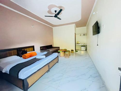 a bedroom with a bed and a ceiling fan at River Valley in Chamoli