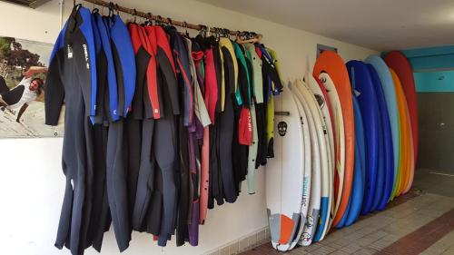 a bunch of surfboards are hanging on a wall at Gijon Surf Hostel in Gijón