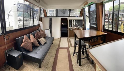a living room with a couch and a table and a dining room at 50ft Stationary House Boat 