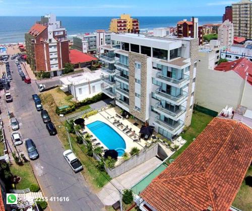 an aerial view of a building with a swimming pool at La Mirage in Villa Gesell