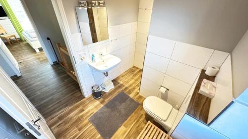 a bathroom with a toilet and a sink at "Bauernhof-Claussen", Haus Welle in Sahrensdorf