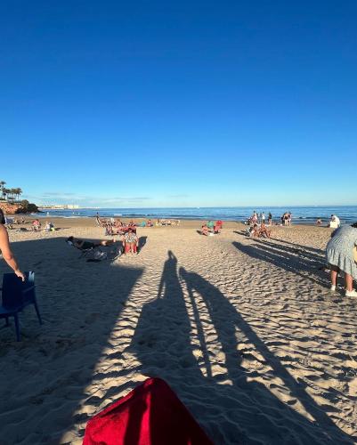 a group of people on a sandy beach at Casa suerte in Algorfa