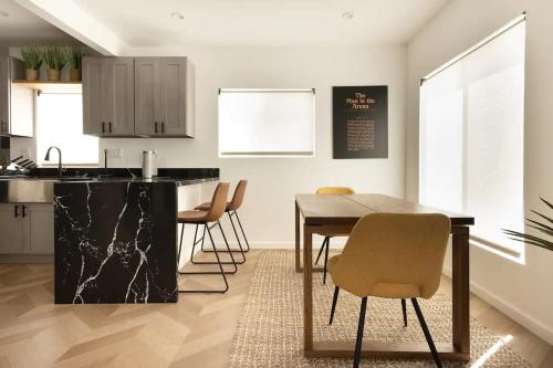 a kitchen and dining room with a table and chairs at Coziest 1BD Bungalow 8min from airport, 4 min SoFi in Los Angeles