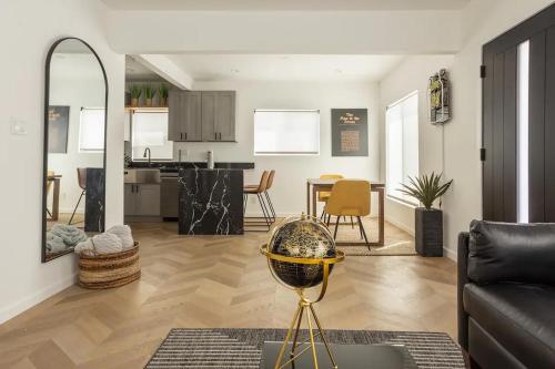 a living room with a couch and a dining room at Coziest 1BD Bungalow 8min from airport, 4 min SoFi in Los Angeles