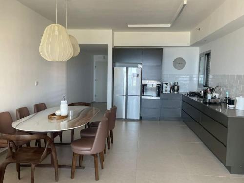a kitchen and dining room with a table and chairs at Blue Sea Angels - Luxury appartment Front Sea in Netanya