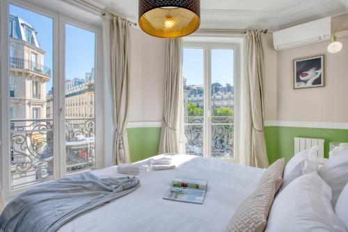 a bedroom with a bed and a large window at Charmant 100m2 avec 3CH - Romantique Centre Ville in Paris