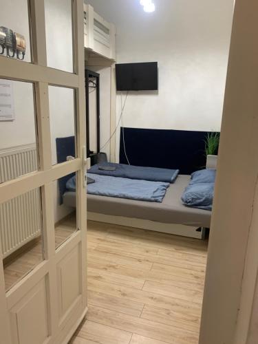 a bedroom with a bed and a sliding door at The Whistling Rabbi in Budapest