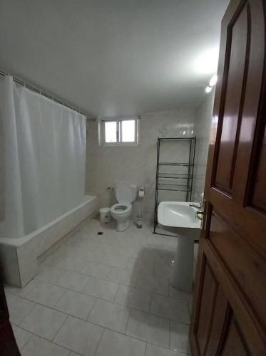 a bathroom with a toilet and a tub and a sink at "Orpheus" - Kalamata Centre in Kalamata