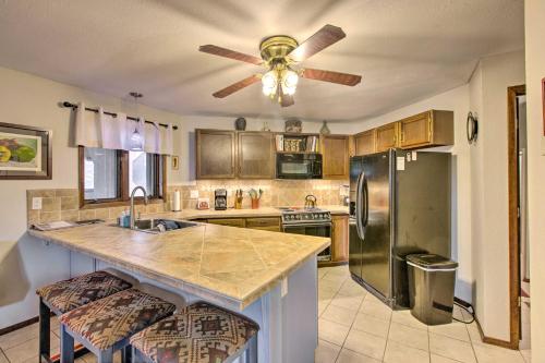 a kitchen with a refrigerator and a ceiling fan at New Mexico Condo with Fireplace and Mountain View in Angel Fire