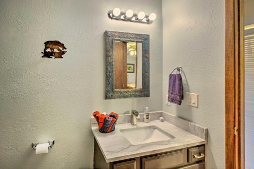 a bathroom with a sink and a mirror at New Mexico Condo with Fireplace and Mountain View in Angel Fire