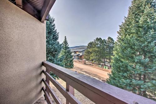 a balcony with a view of a house and trees at New Mexico Condo with Fireplace and Mountain View in Angel Fire