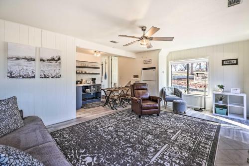 a living room with a couch and a table at Dock and Pool Access Lakefront Grove Home! in Grove