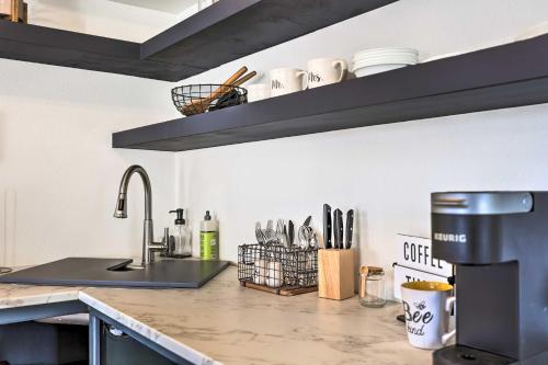 a kitchen with a sink and a counter top at Dock and Pool Access Lakefront Grove Home! in Grove