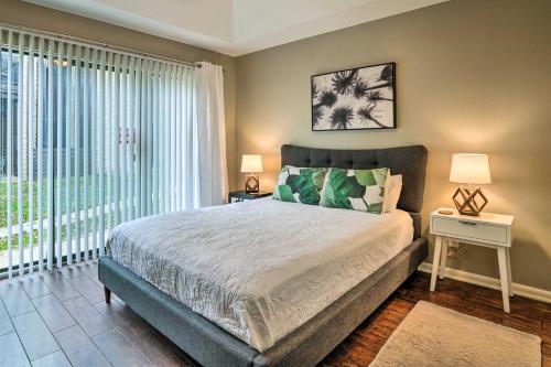 a bedroom with a bed and a large window at Graham Haus River Condo Walk to Schlitterbahn! in New Braunfels