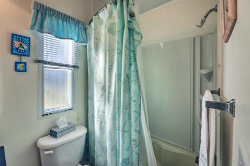 a bathroom with a shower curtain and a toilet at Atlantic Beach Home with Decks and Fire Pit in Atlantic Beach