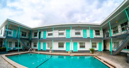 an exterior view of a building with a swimming pool at Uptown Inn & Suites in St. Petersburg