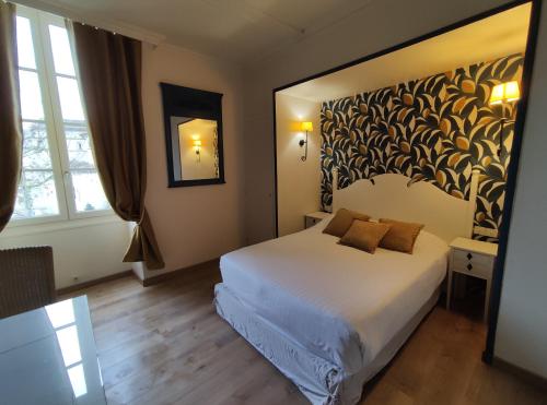 a hotel room with a bed and a large window at Le Pavillon Saint-Martin in Souillac