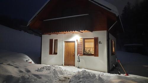 a house with a door in the snow at night at Domki Partecznik Wisla in Wisła