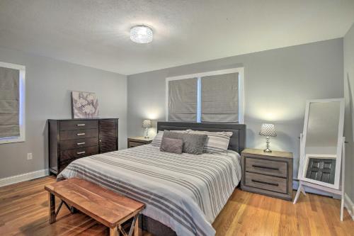 a bedroom with a large bed and a wooden floor at Modern Middletown Retreat, Minutes to Downtown! in Middletown