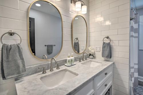 a bathroom with two sinks and two mirrors at Modern Middletown Retreat, Minutes to Downtown! in Middletown