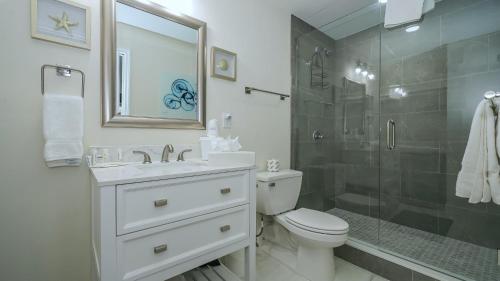 a bathroom with a sink and a toilet and a shower at All-New, Private, Huge TV, Heated Pool, Tiki Bar in Sarasota