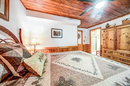 a bedroom with a bed and a wooden ceiling at Rivers Edge in Suches
